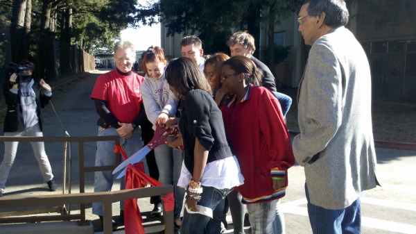 students cutting ribbon