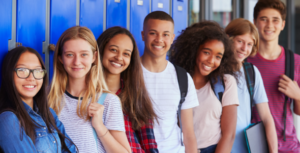 High school students standing in front of lockers and smiling.