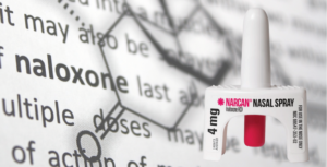 Image of naloxone drug description with bottle of Narcan spray applicator in the foreground.
